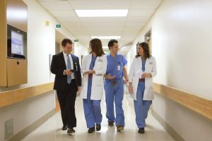 Our Practice - Group walking down hall